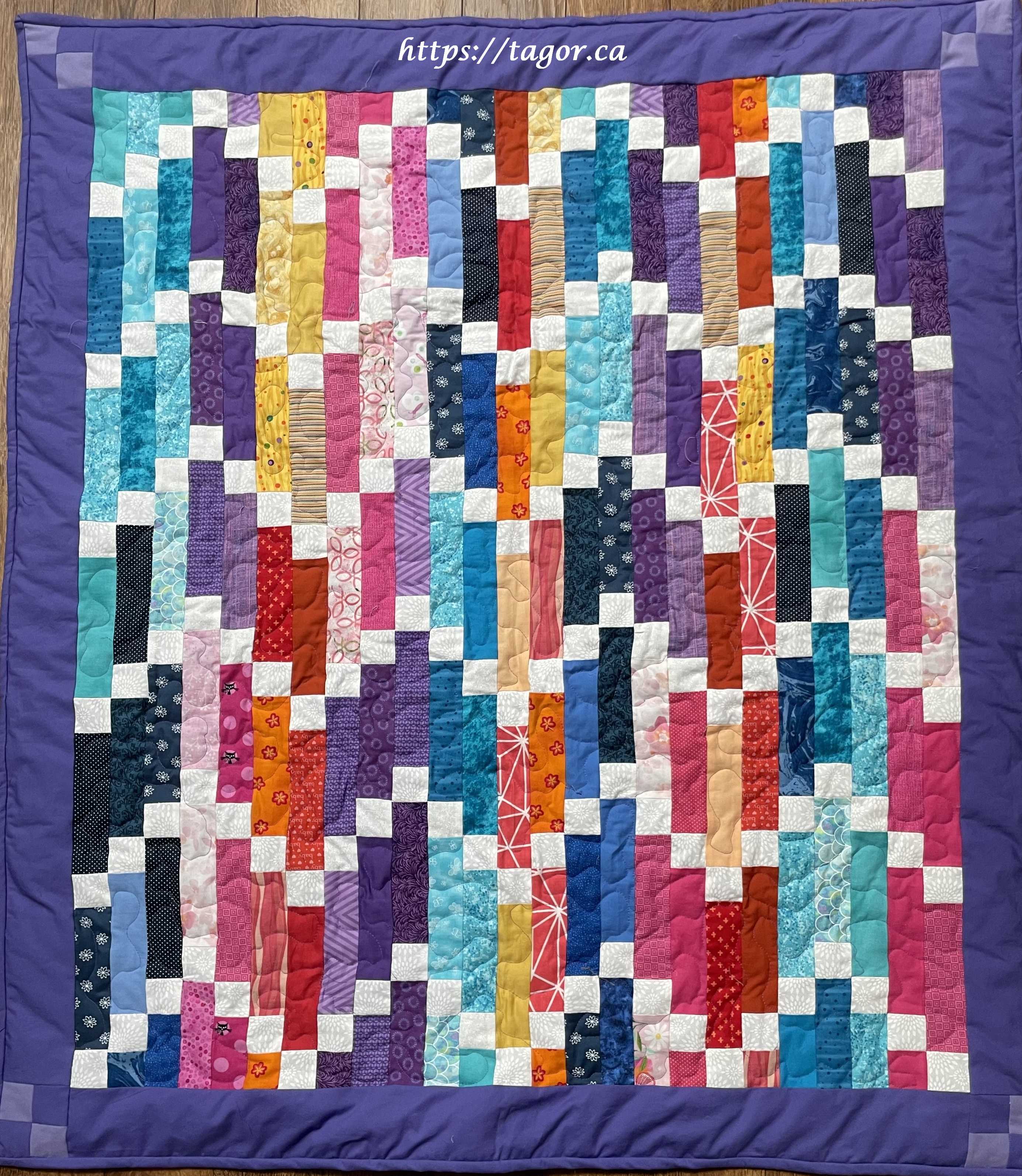 Elly using up scraps created this colourful wonder tied together with a perfect purple border